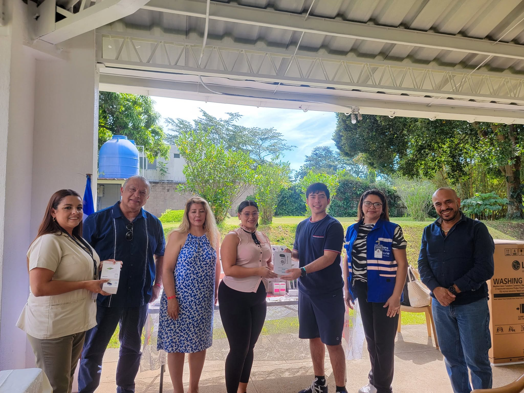 Handing a boxed health device to a local representative